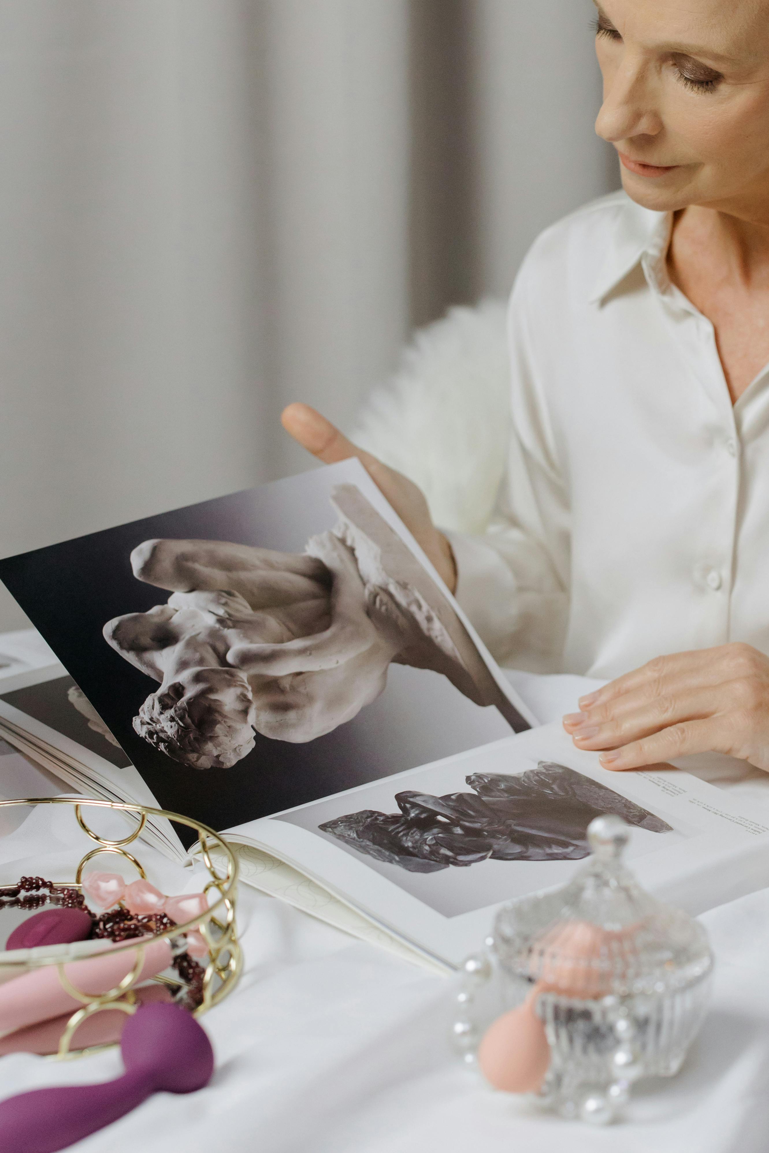 woman holding photo book on marble table
