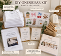 DIY Onesie Bar Kit bundle displayed on a styled tabletop with labeled callouts showing included items: a stack of white cotton onesies, printed onesie bar cards, wooden clothes pins, twine, a heat press, instruction booklet, and a bonus baby shower playbook.
