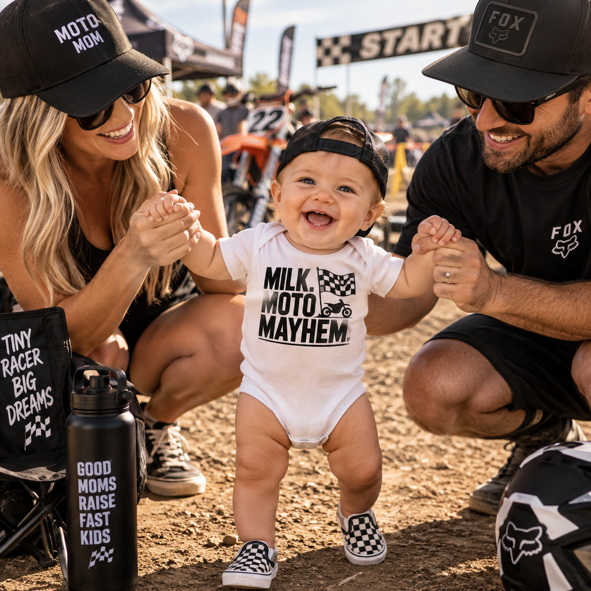A baby wearing a white onesie with 'MILK. MOTO.